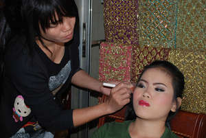 Channa (left) practices makeup application