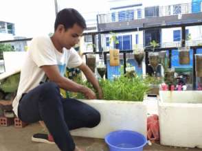 Scholar, Pha, working on his home garden