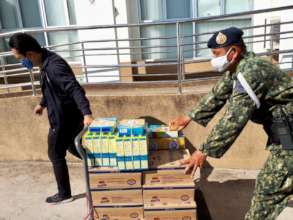 A soldier helps us deliver formula.