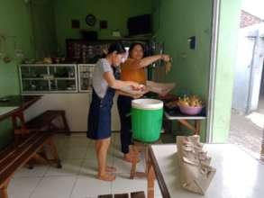Food stall owners preparing food for collectors