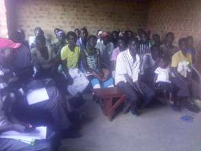 The community listening to the facilitator