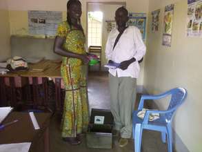 Member of the association handing over a cash box