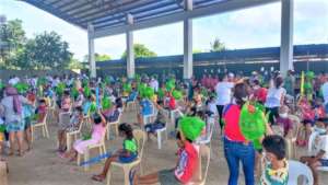 Students seated to receive AAI package and a toy