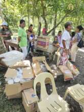 Voulunteers preparing cooked rice for survivors