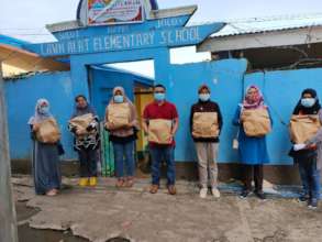 Parents pick up AAI relief packs at Sulu School