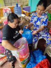 Volunteers packing rice for relief packages