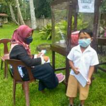 Students receive a health check upon returning