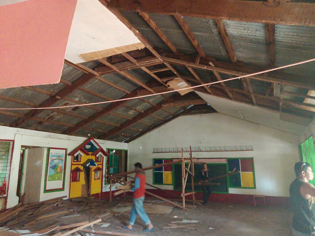 Parents repair classroom after typhoon damage