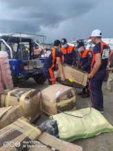 Fire fighters assist AAI carrying incoming aid