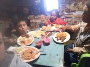 Families enjoying their dinner at home