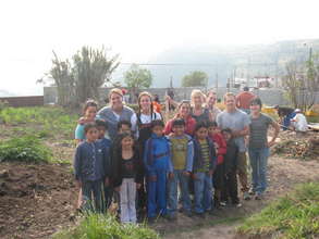 Group of Volunteers and Local Children