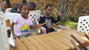Learning to play the amadinda (local Xylophone)