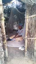IDP woman in her hut in the bush