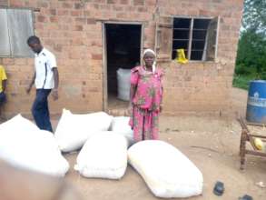 Grandma Jereva with her son packing maize harvest
