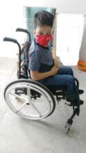 Andreas receiving a new wheelchair