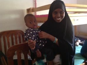 Habiba carrying Annan after her nap