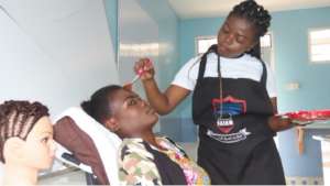 Sarah practicing her makeup skills on a volunteer