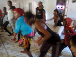 The girls smiling and dancing during Zumba class