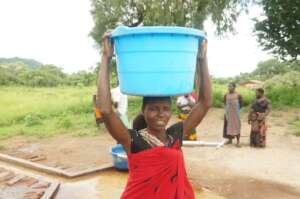 With thanks, she carries the healthy water home.