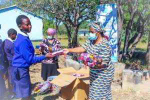 School girls receiving reusable cloth pads.