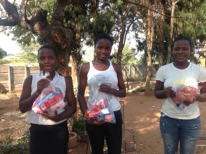 Girls receiving dignity packs