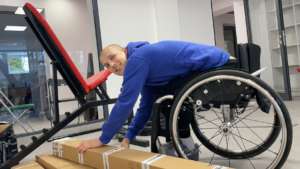 Matthew unpacking rehabilitation equipment.