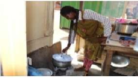 A mother in her kitchen using Grass charcoal