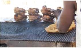 A Kehbah seller roasting meat/ fowls for sale