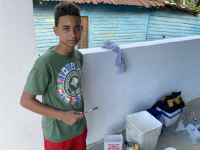 Community members painting the health center