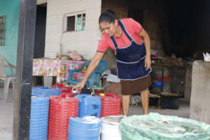 In photo, a women save water for domestic use