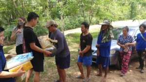 Giving food to Burmese migrants at a camp