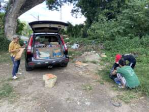 Giving food packet to a struggling family