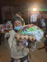 A lady in remote area of Pai receives food pack.