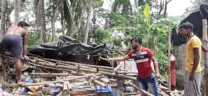Youth group members repair houses in their village