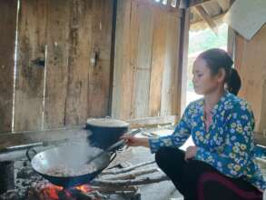 Cooking volunteer is preparing meals for children.