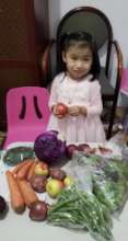 Little girl opening our hunger relief box