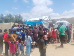 A huge line of people waiting for hot meals