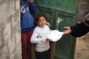 A young girl, happy to receive a delivery from MNK