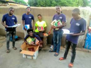 Tweens donating books in camp