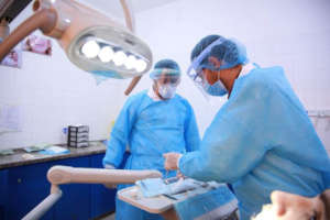 Dentist at Al Awda Hospital wearing PPE