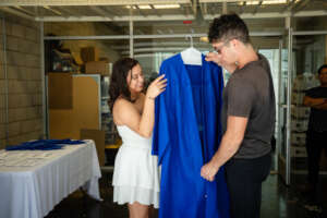 Graduate Getting in His Robe for Graduation