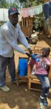 DCC Physio gives Emmanuel a facemask and handwash