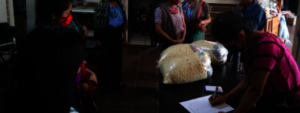 Chonita signing in people for their food packages