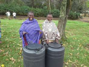Two grandmothers with water harvesting tanks