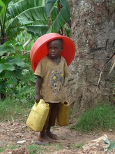 Joyce's grandson fetching water from the well