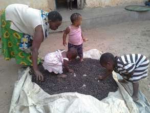 Enid drying her coffee with her grandchildren
