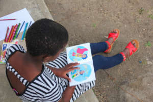 Young Girl at Home With Donated Learning Resources