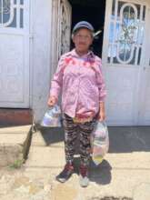 Community member and her food basket