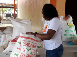 Volunteer Tracy packaging food to distribute