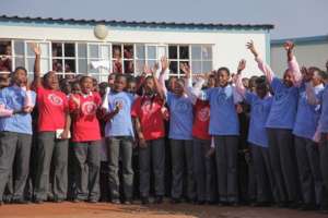 Participants gather outside their school